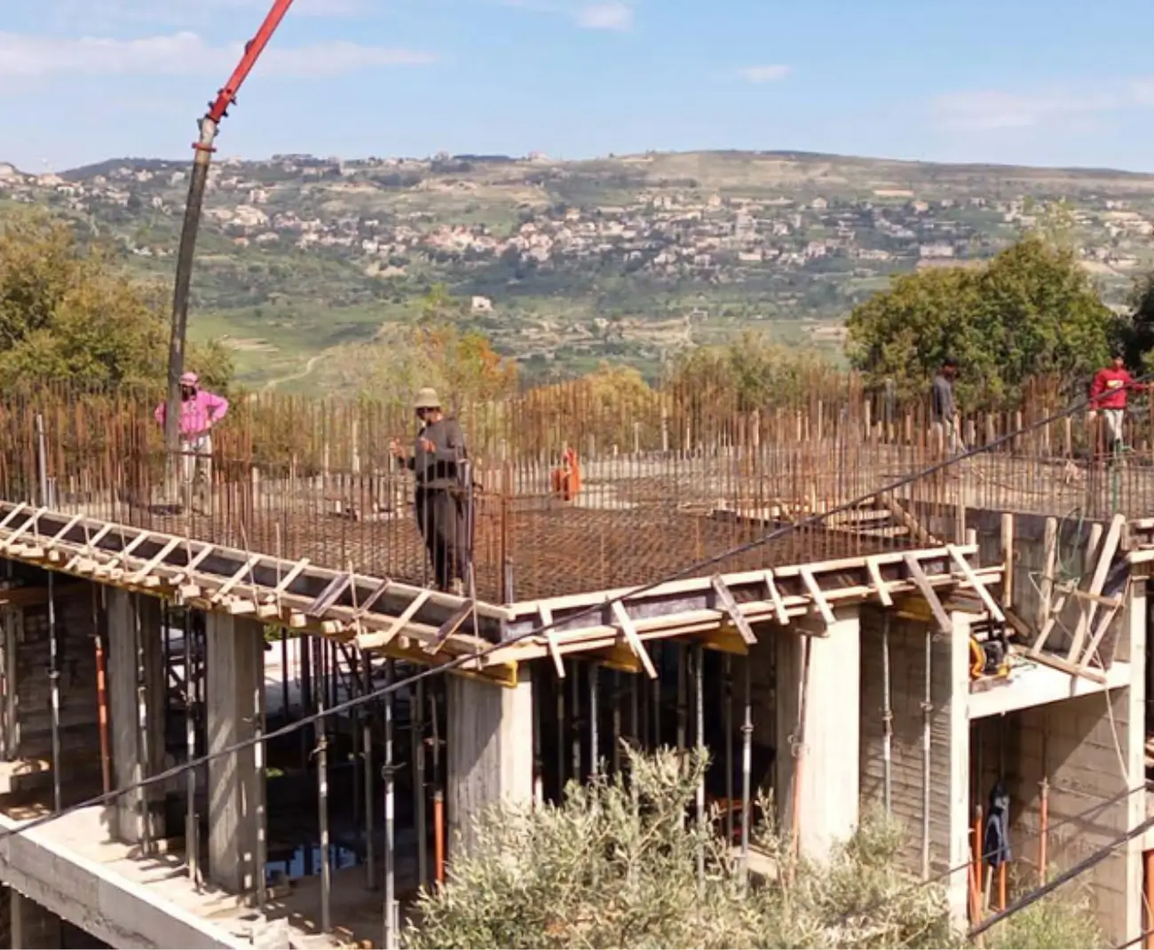 Group Four site crew working on a slab pour with edge formwork and props in Lebanon