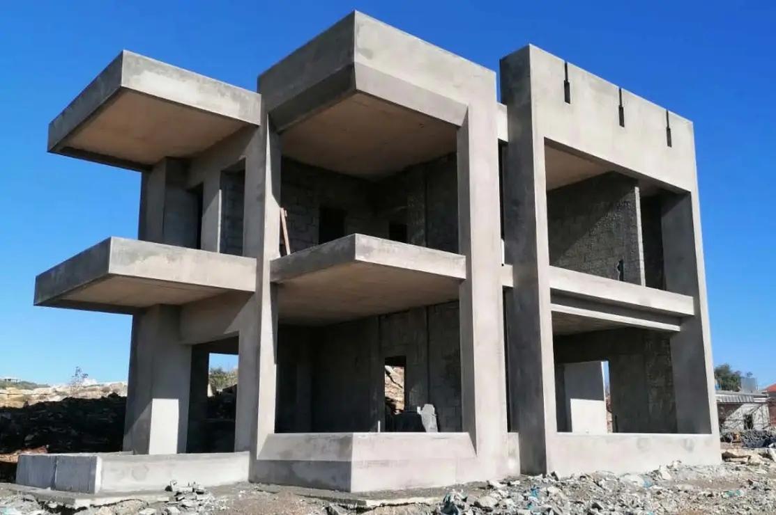 Louay Beaini residence structural framework progress — stone cladding installation Mazraa El Chouf Group Four