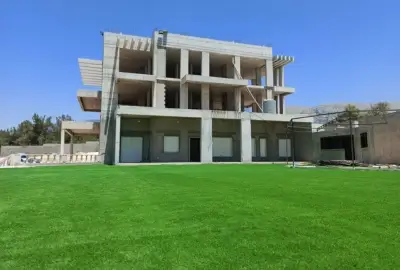 Zeinedinne villa structural frame progress above football field Botmi El Chouf — Group Four